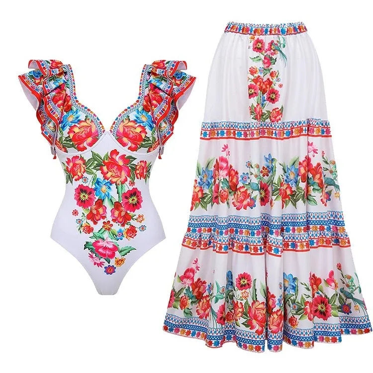 Adult woman modelling a printed one-piece swimsuit in a choice of colours including rose pink, blue, white, and a red apron set style.