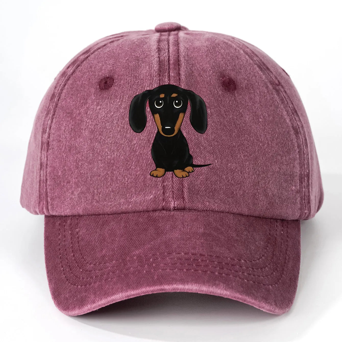 Retro washed blue cotton baseball cap with a printed dachshund design on the front and a peaked brim.