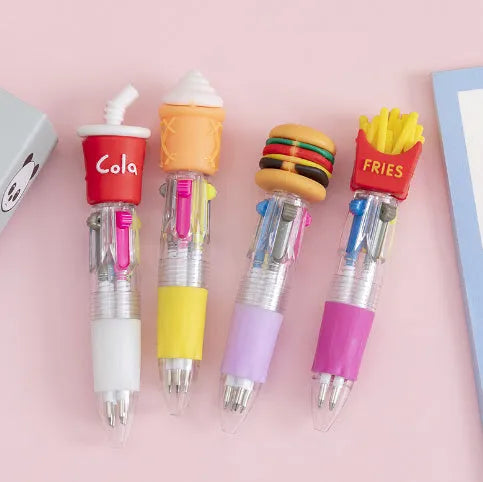A cartoon-themed press-type ballpoint pen showing four-colour cartridge and a random print design on a silicone and plastic barrel.