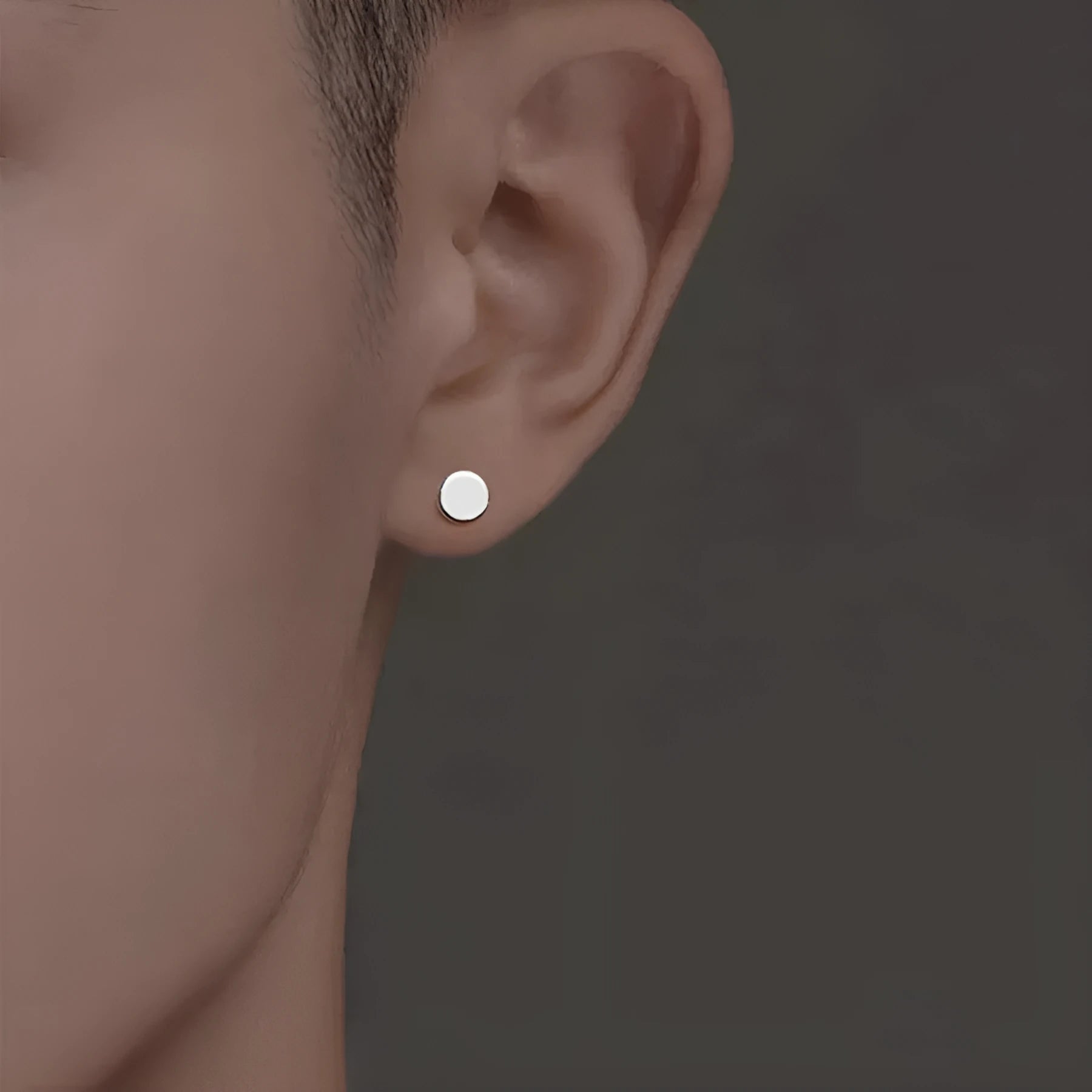 A pair of S999 sterling silver round flat stud earrings on a plain background, showing silver and black colour options.
