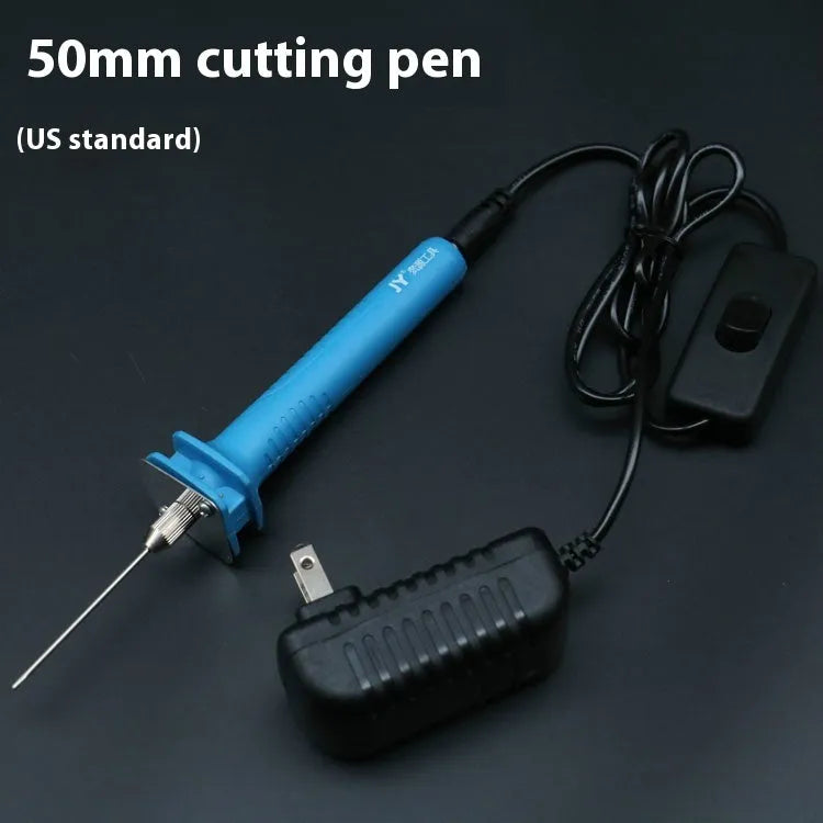 Blue plastic-handled electric foam cutter pen with adapter on a work surface.