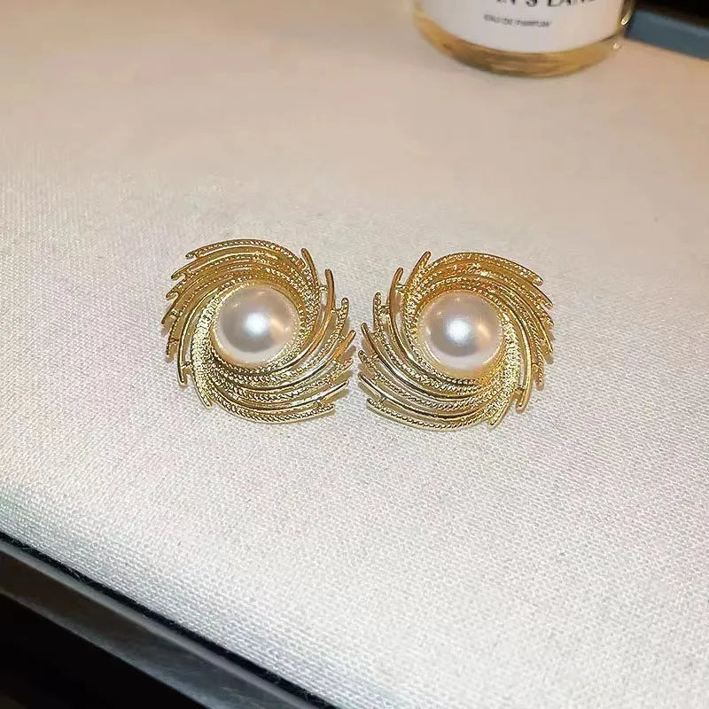 Gold plated pearl earrings with irregular flower shape design on alloy stud backs