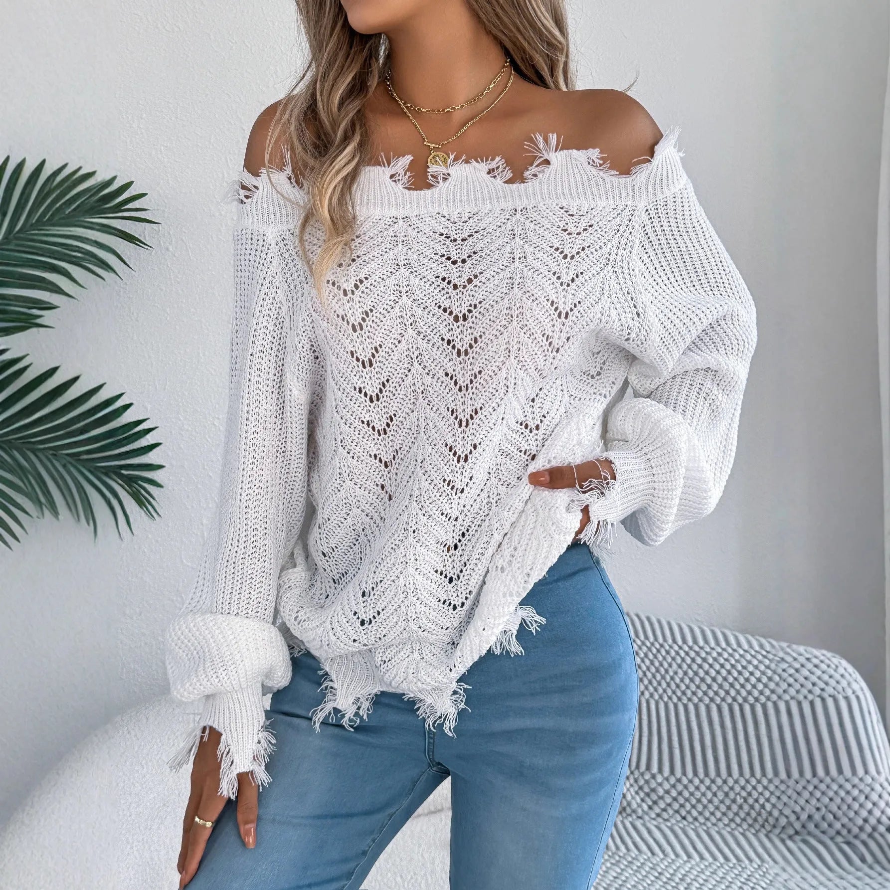 White hollow-out off-the-shoulder pullover sweater with long sleeves on model
