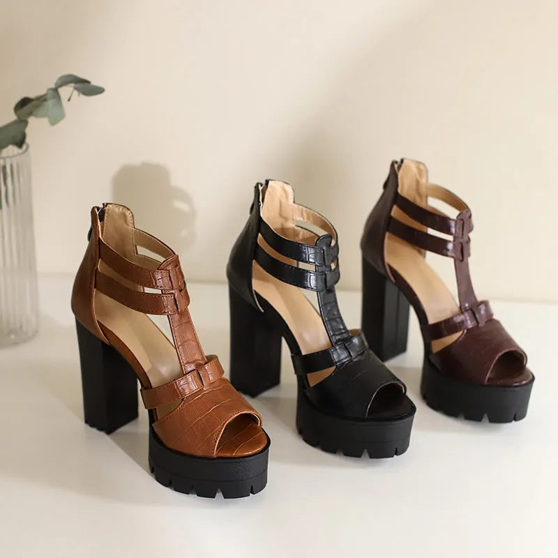 Women's black platform high heel sandals with ankle strap and back zipper on a round toe.