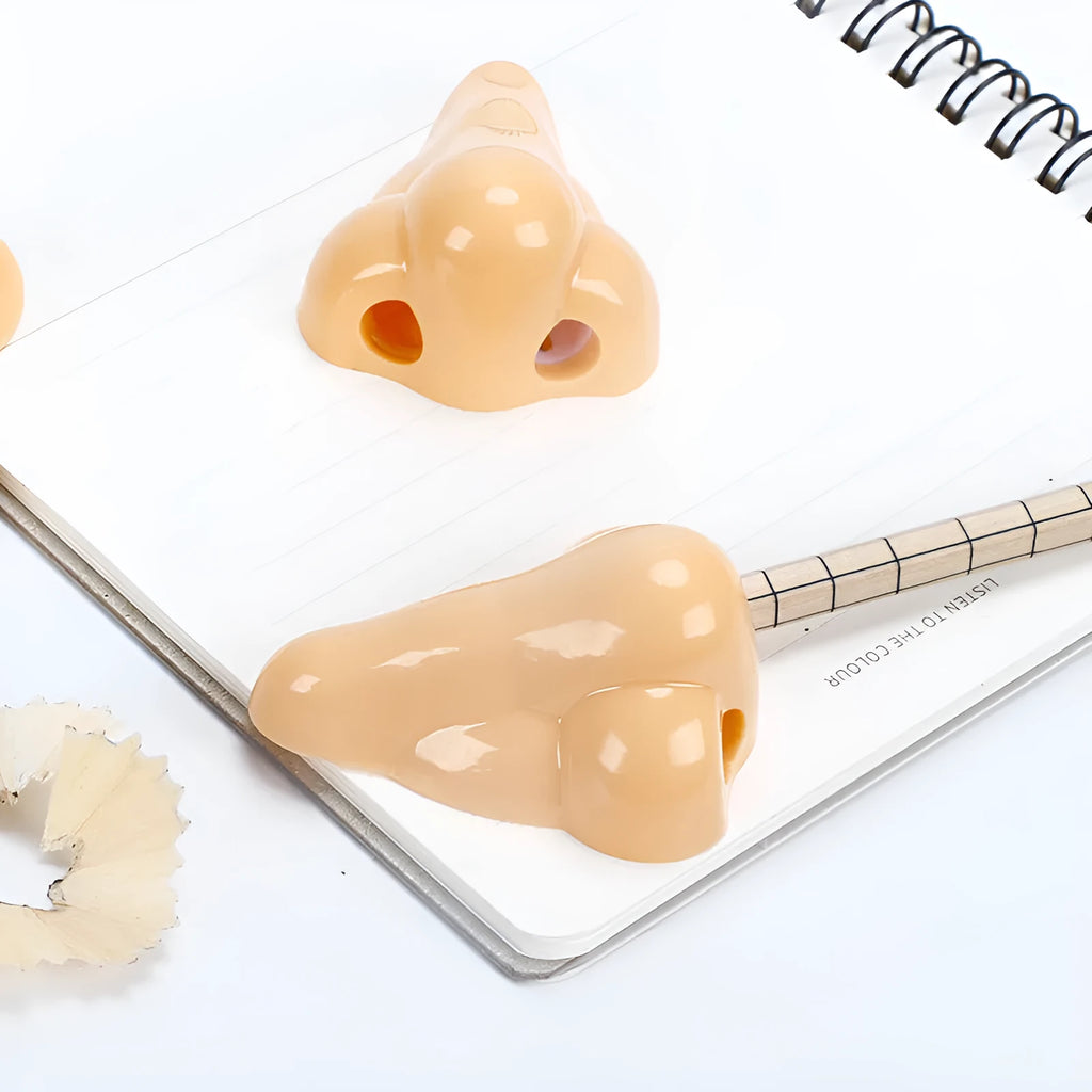 Flesh-coloured geometry-shaped pencil sharpener with big nostril design measuring 58x45x30mm