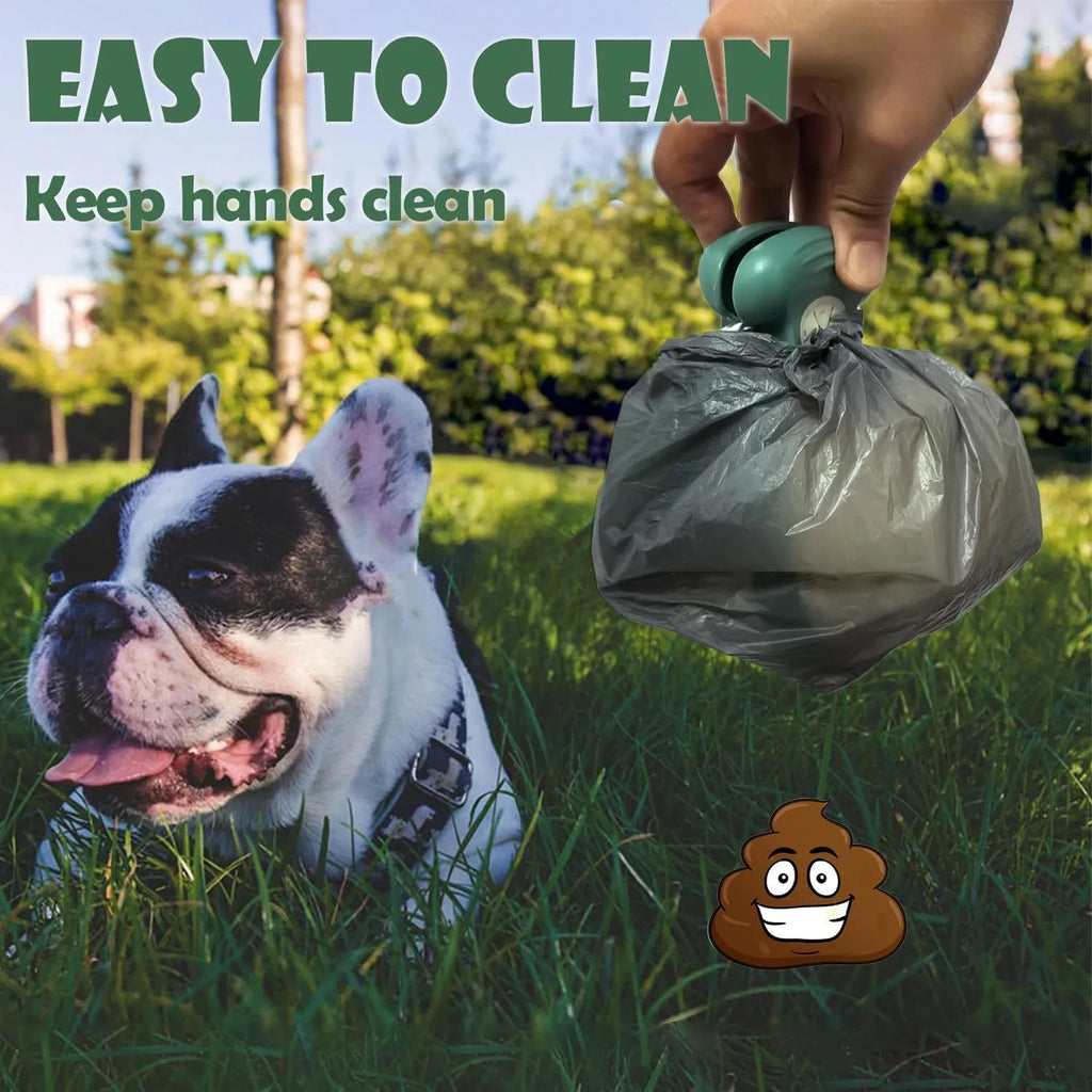 Blue handheld dog pooper scooper with clip and bag dispenser on a green background.