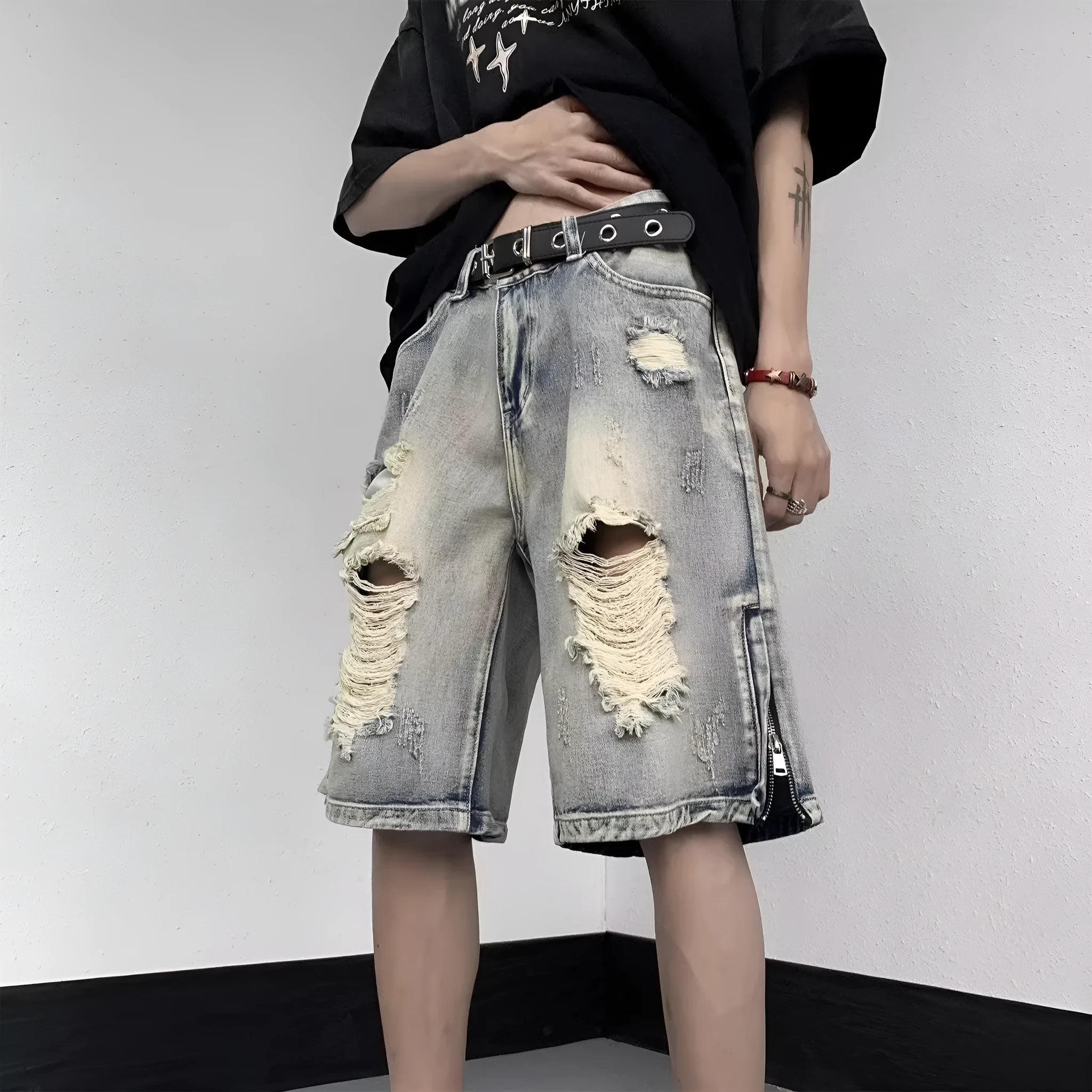 Blue retro tattered denim shorts with a wide leg loose fit on a mannequin