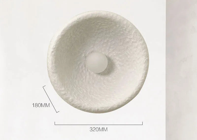 Japanese-style simple silent wall lamp with resin shade in three diameter sizes on white wall