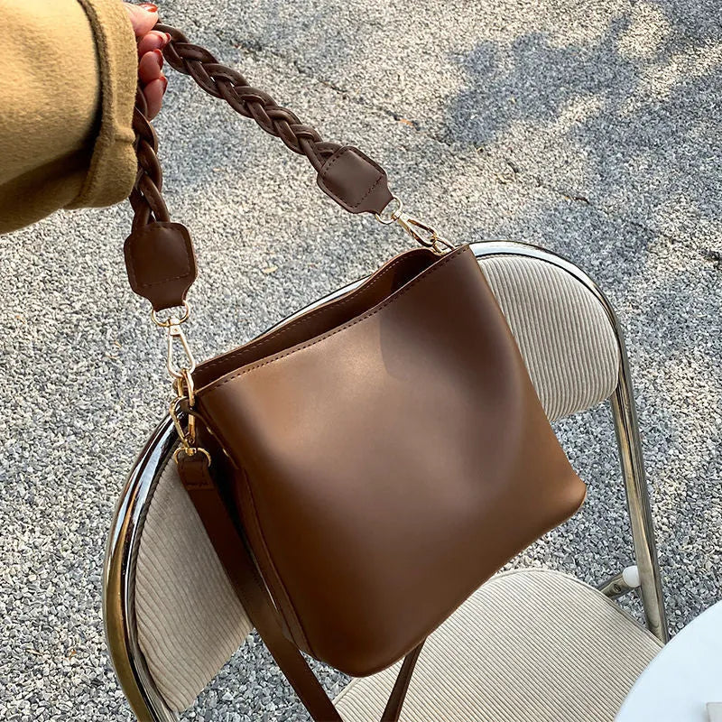 Retro woven PU bucket bag in khaki colour shown as crossbody and underarm bag