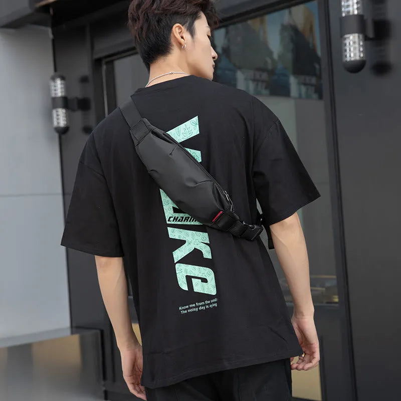 Black Oxford cloth waist pack with crossbody strap showing zipper closure