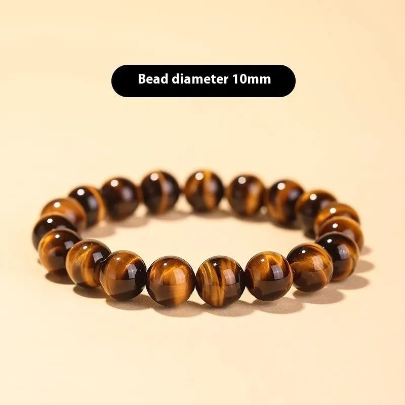 Tigereye Dzi bead single circle Buddha rosary bracelet on a wrist.