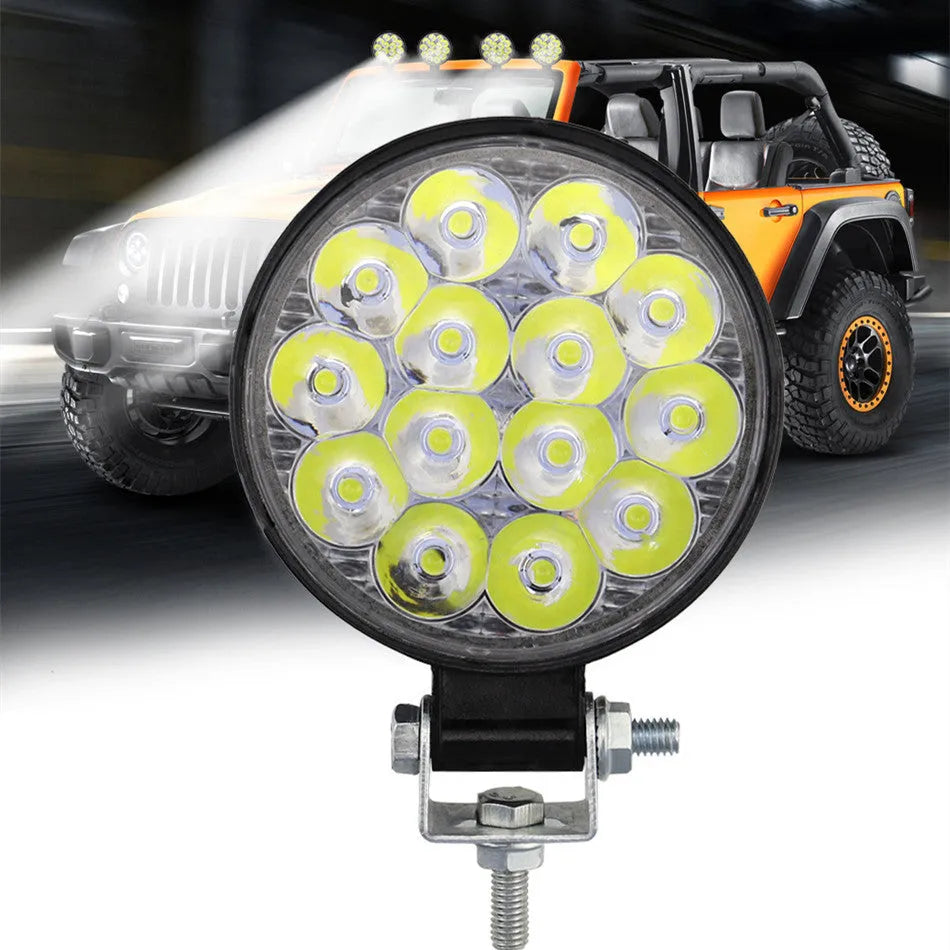 Compact round aluminium LED work light for cars and off-road vehicles with white light output.