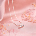 Silver necklace with cherry pendant on an adjustable snake bone chain.
