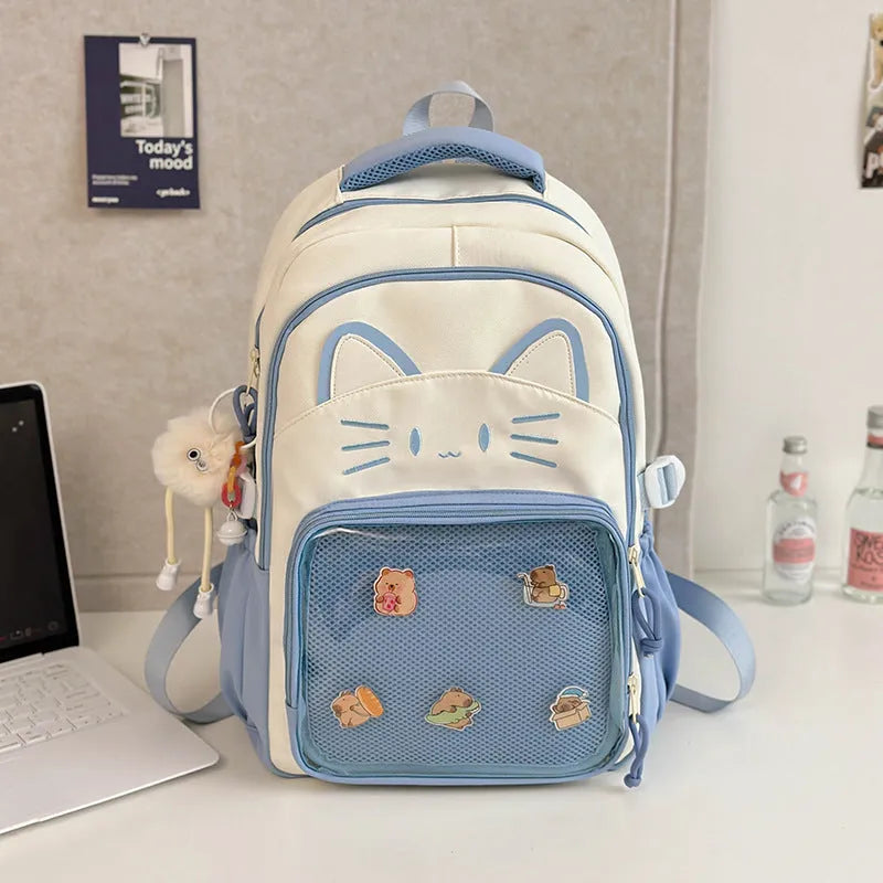 Cartoon print large capacity nylon backpack in pink with badge pendant, shown with curved shoulder straps.