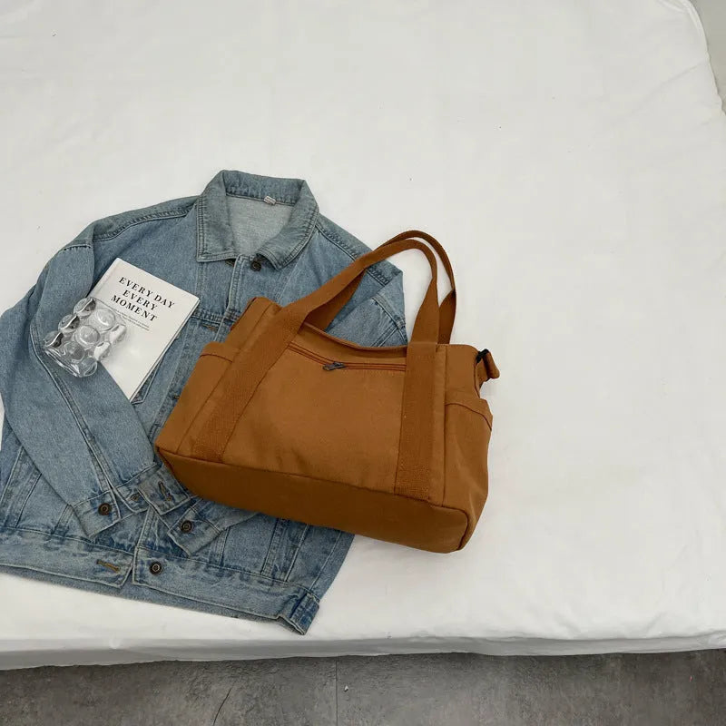 Women's polyester shoulder bag in solid colour with external pocket and internal phone compartment