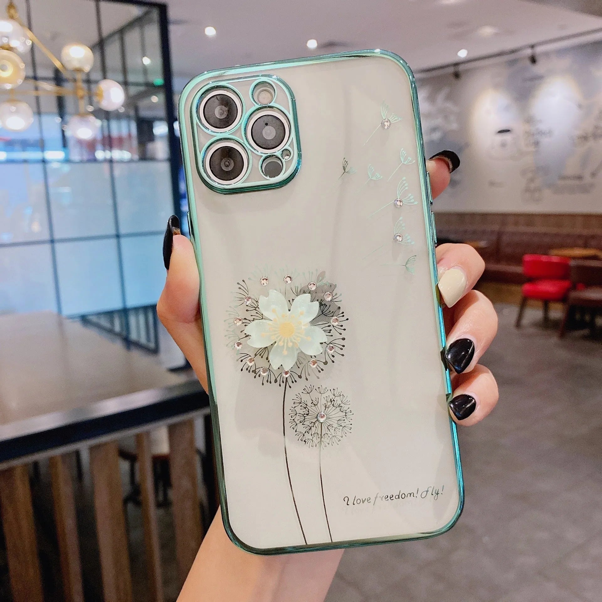 Green silicone iPhone case with a 3D floral design and a built-in spin stand on a white background.