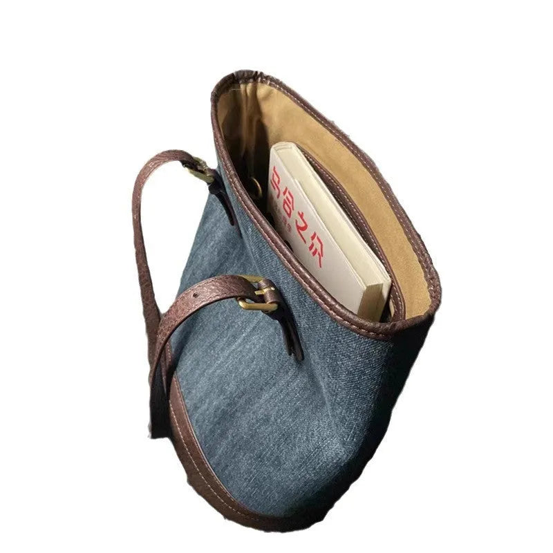 Blue denim patchwork one-shoulder bucket handbag with a large opening.