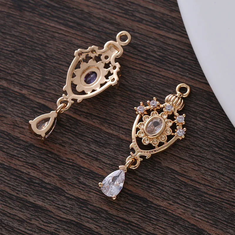 Water drop shaped pendant with crown design and micro inlaid zircon detail in electroplated copper.
