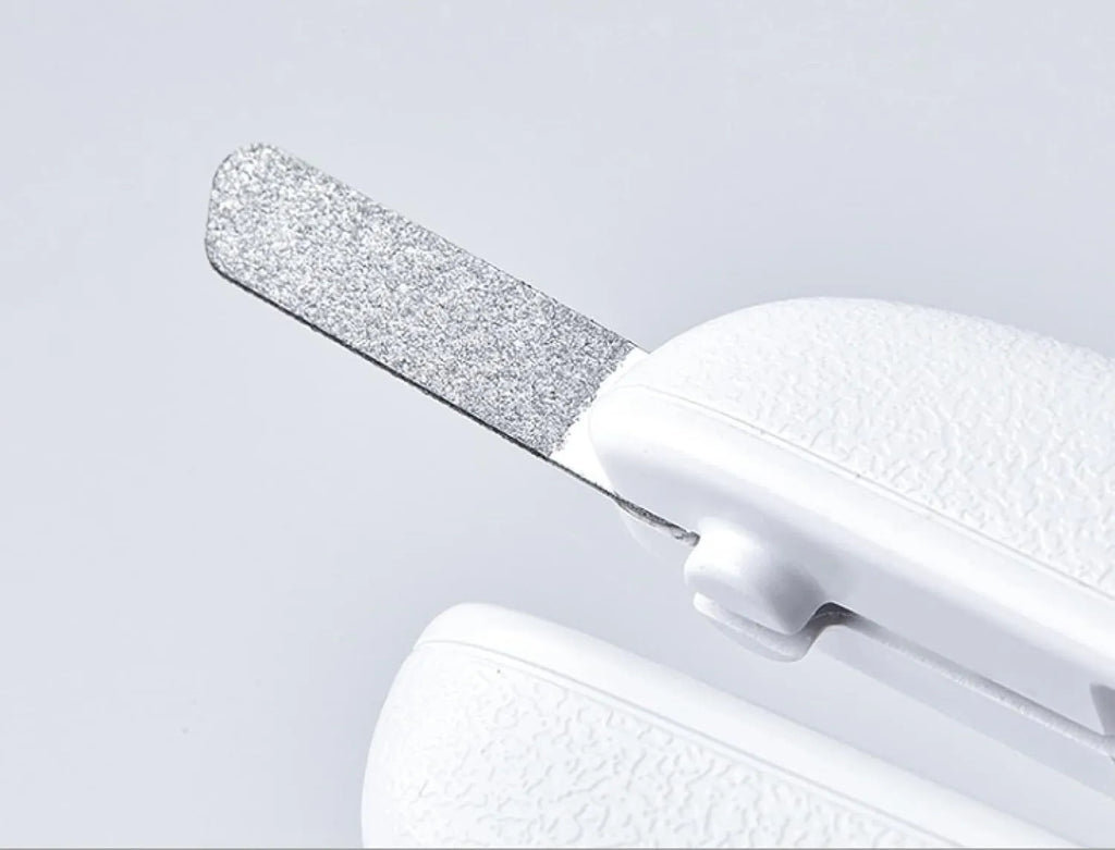 White pet nail clippers with LED light, transparent splash guard, and anti-slip handle.
