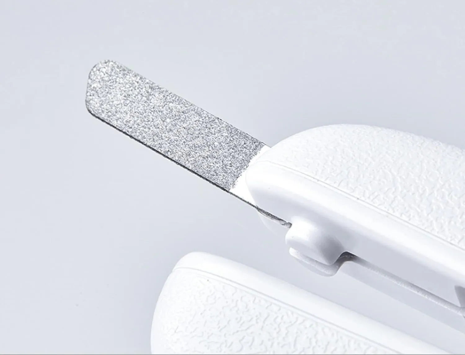 White pet nail clippers with LED light, transparent splash guard, and anti-slip handle.
