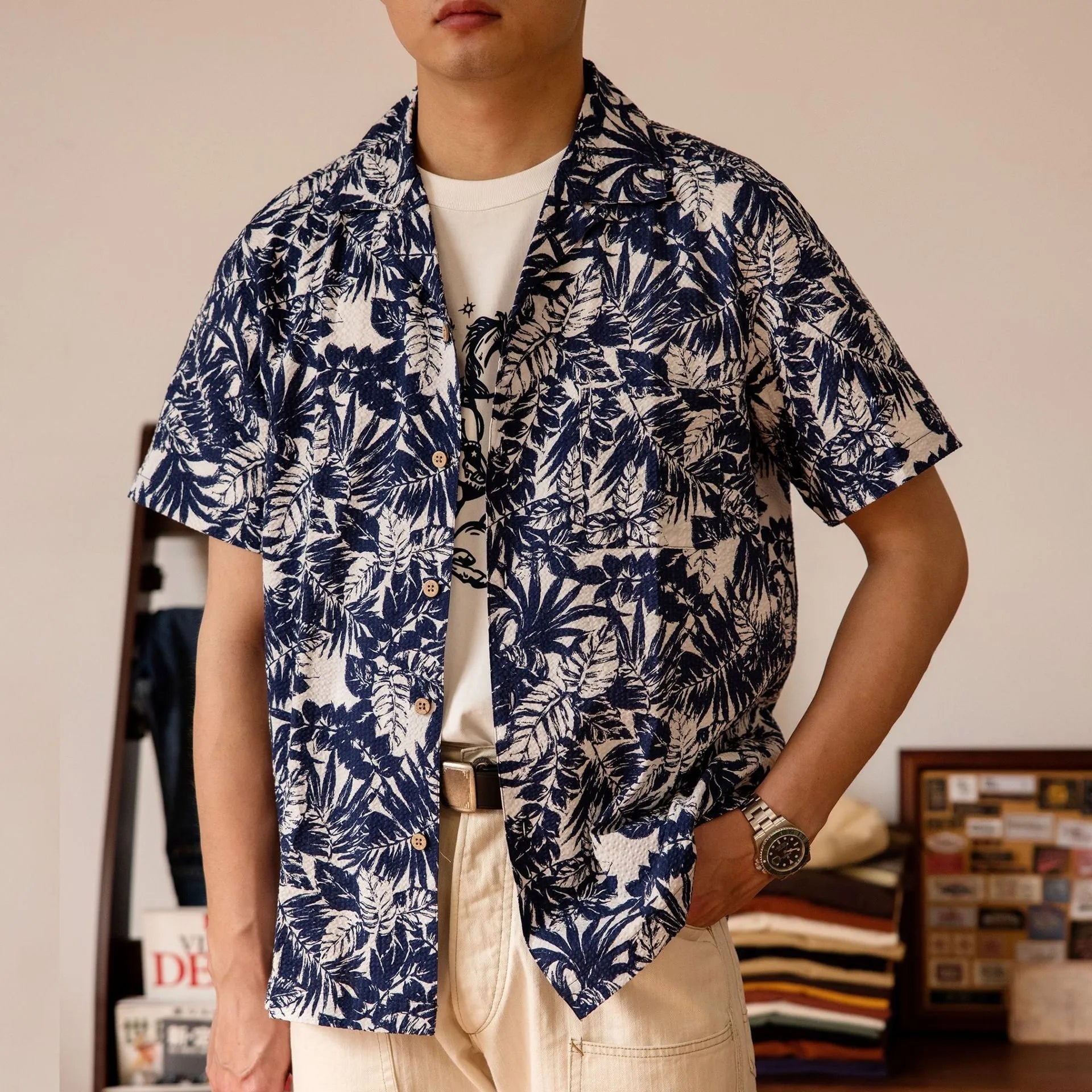 Men's green seersucker shirt with floral print and a Cuban collar, laid flat.