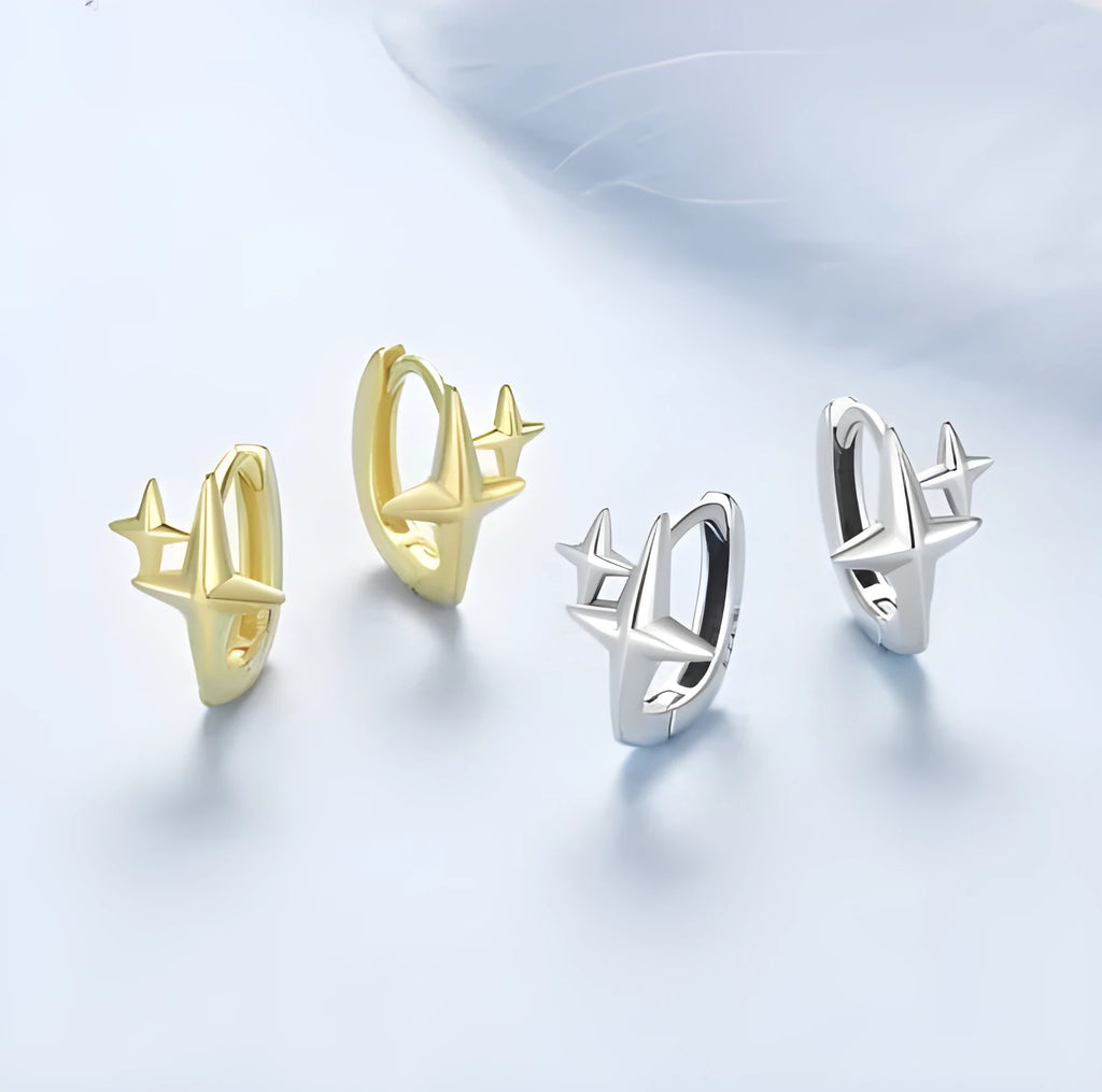Minimalist oxidised sterling silver star ear clip with XINGX detail on a white background.