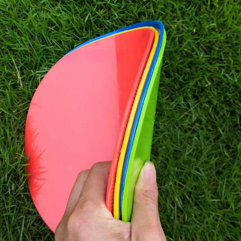 Soft yellow TPE football training landmark pad on grass, showing 23cm diameter.