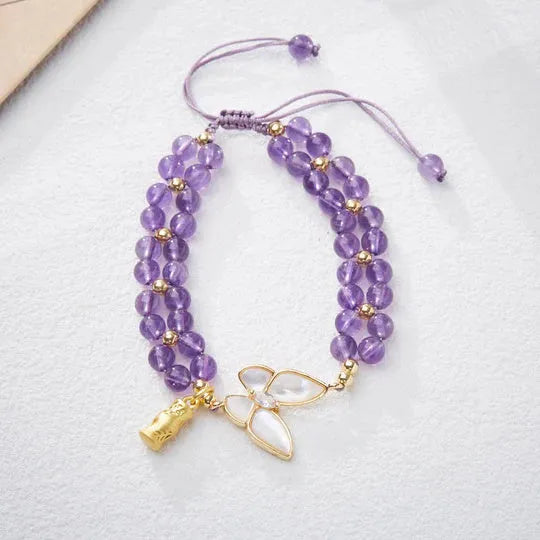 Handmade purple amethyst crystal bracelet with multi-treasure natural stone beads on white background