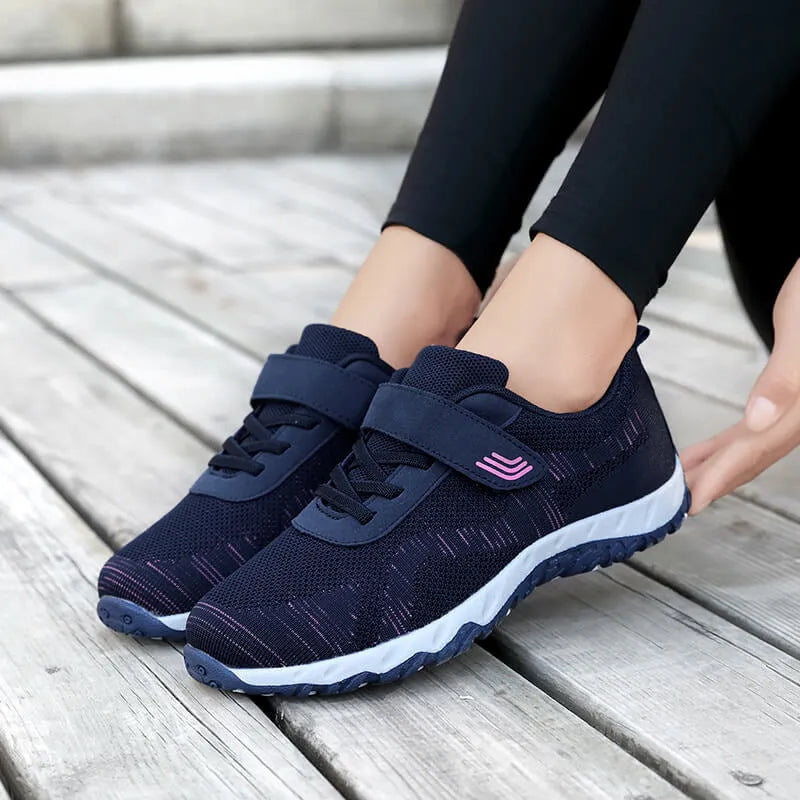 Women's low-top wedge heel shoes with mesh upper and Velcro strap in a solid colour.