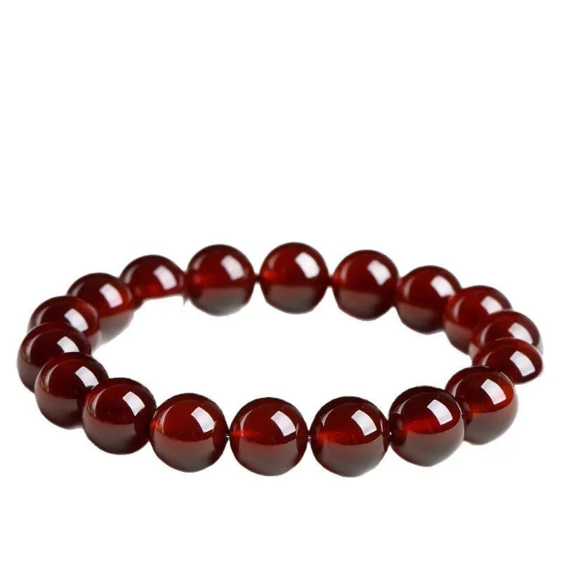 Natural orange red garnet crystal bracelet with Ruyi design elements on wrist