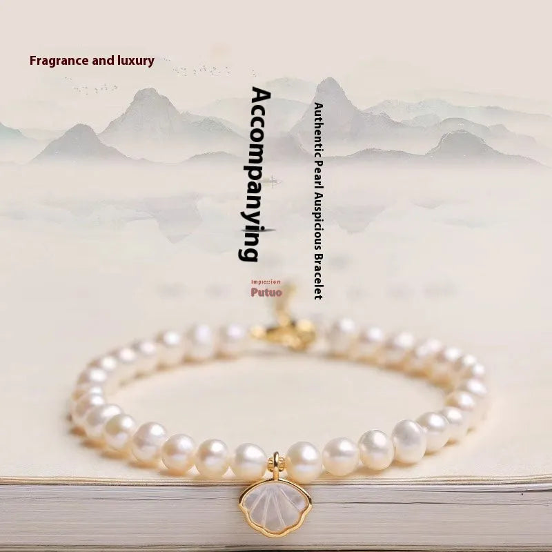 Women's freshwater pearl bracelet with fan design on a 16cm band, showing elastic string and extension chain options.
