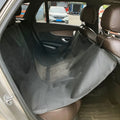 Washable cloth car pet mat for rear seat protection with dog bone print design.