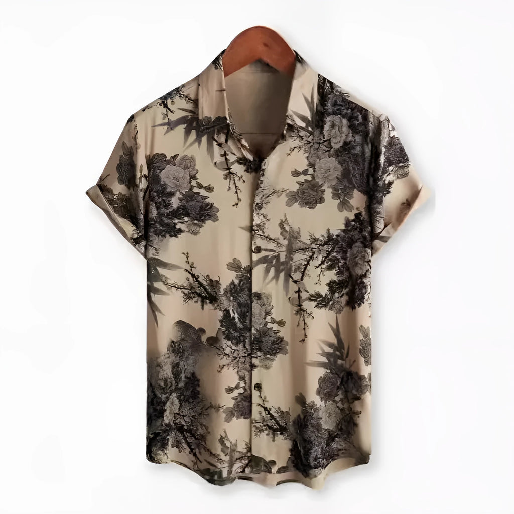 Man wearing a short sleeve lapel collar Hawaiian shirt with a blue floral print.