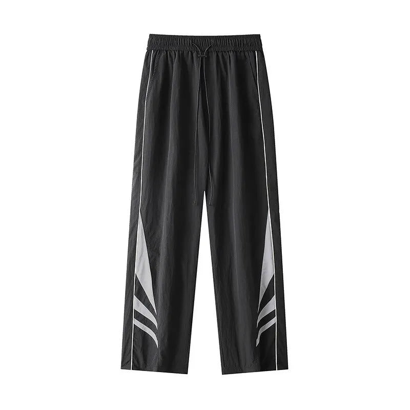 Men's straight leg summer sports trousers in grey, showing loose fit and button fly.