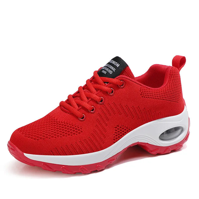 Women's black mesh sneakers with front lace-up and round toe, showing mid-heel profile