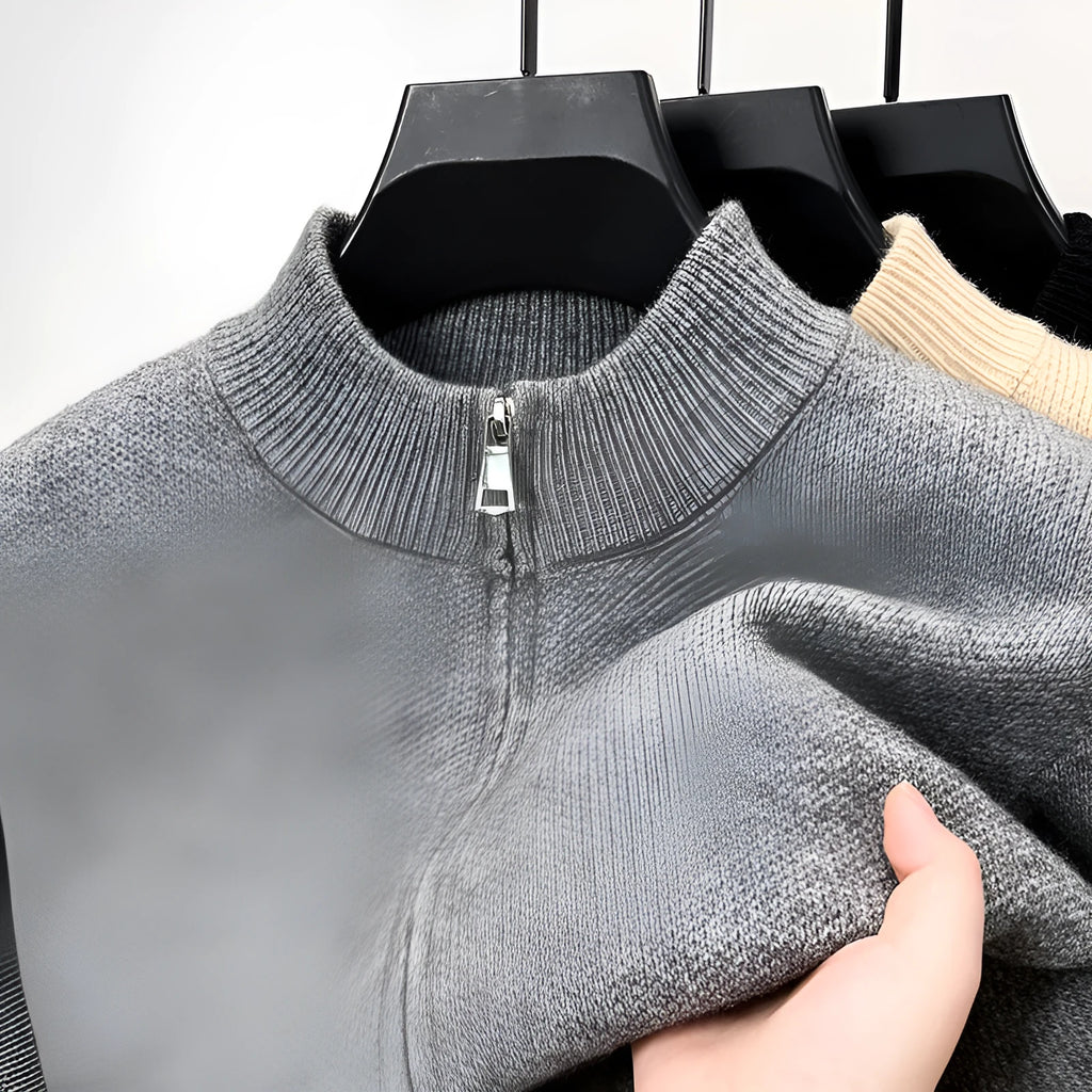 Men's black zip-up knitted cardigan with a stand collar on a hanger