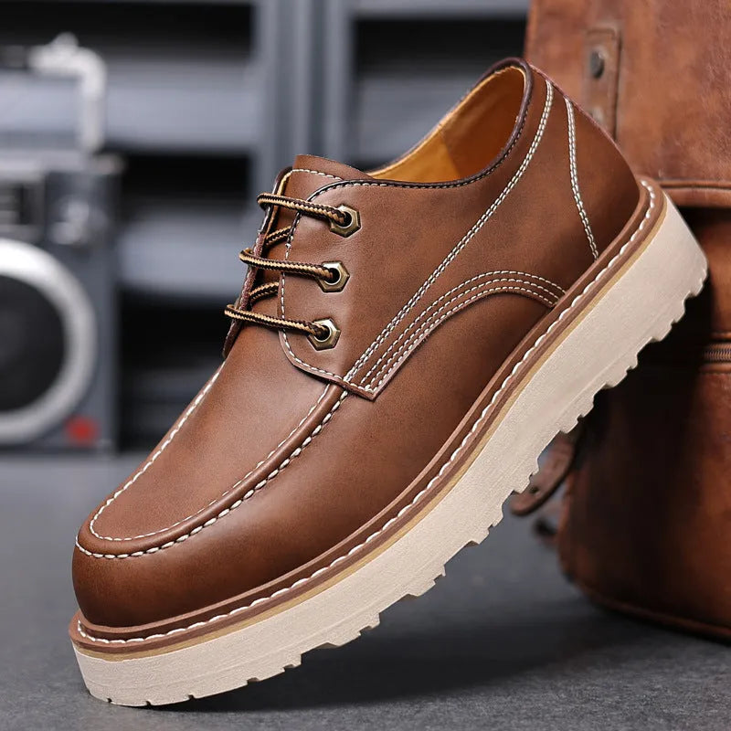 Men's black low-top Martin boots with round toe and rubber sole on a white background.
