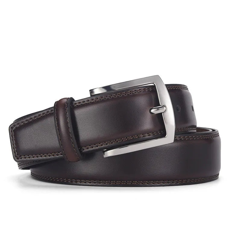 Men's black genuine leather belt with a silver alloy pin buckle on a flat surface