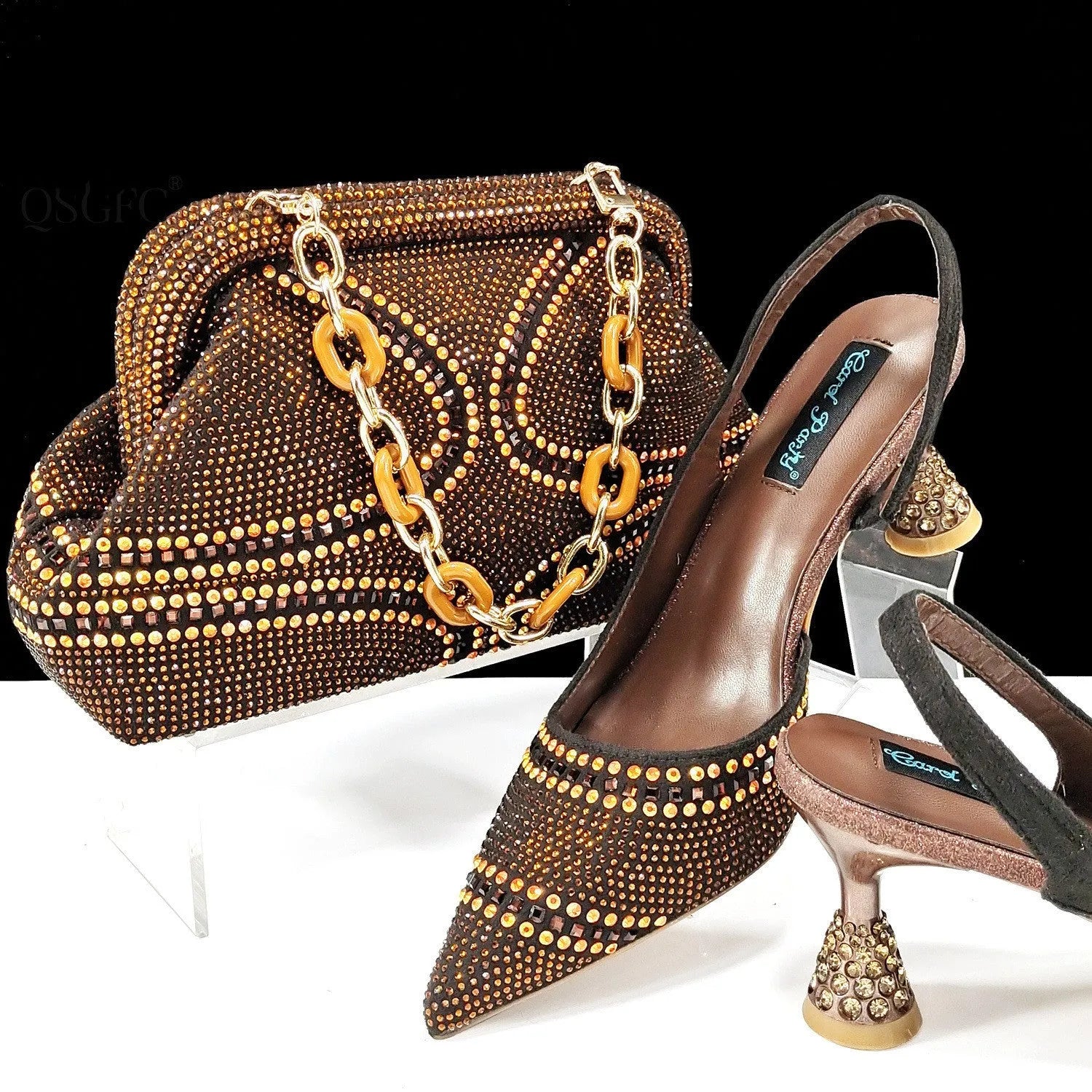 Women's pink pointed toe high heel shoes with rhinestones and a matching small clutch bag.