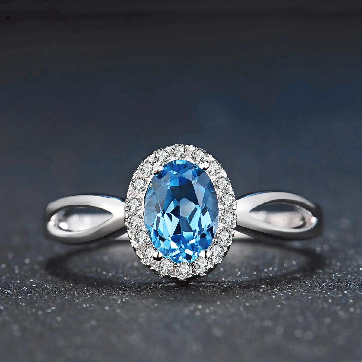Four-piece 925 sterling silver jewellery set with blue topaz stones: geometric necklace, earrings, ring, and pendant.