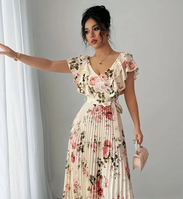Apricot floral print v-neck dress with ruffled sleeves and a long, pleated swing skirt.