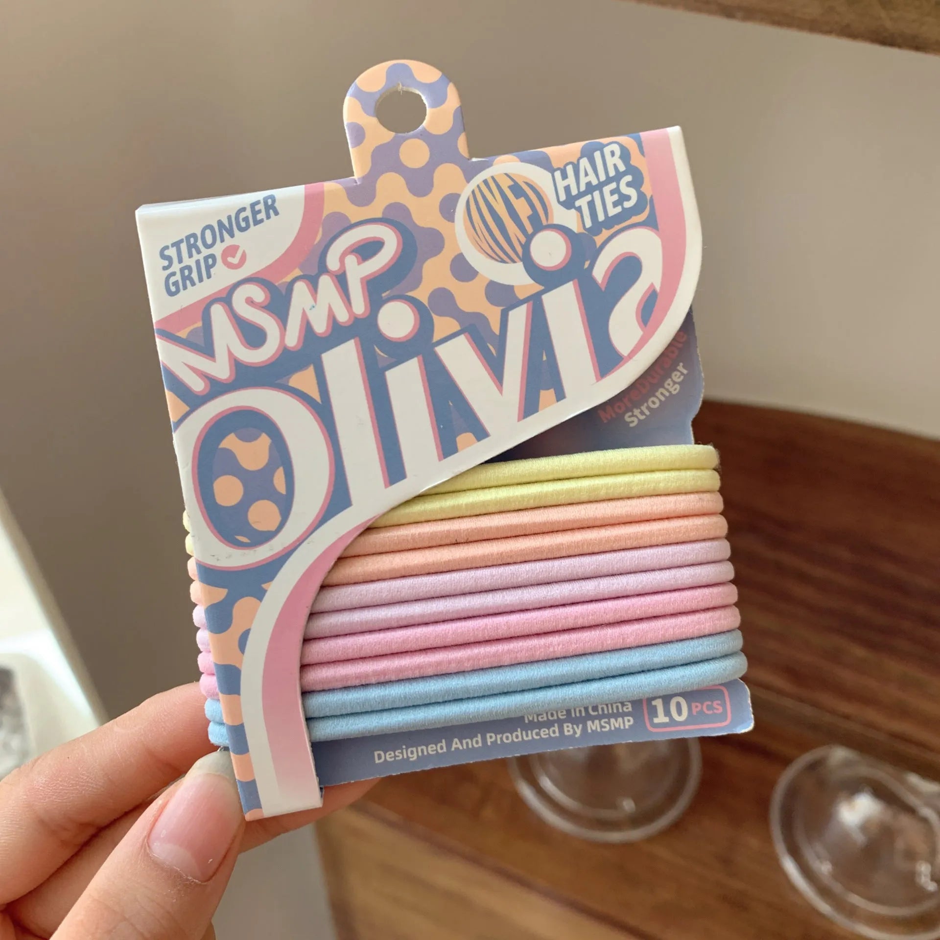 Assortment of candy-coloured braided elastic hair ties on a white background.