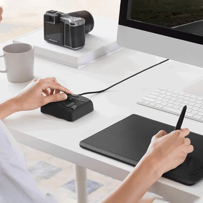 TourBox NEO black digital tablet auxiliary keyboard for video editing on a desk