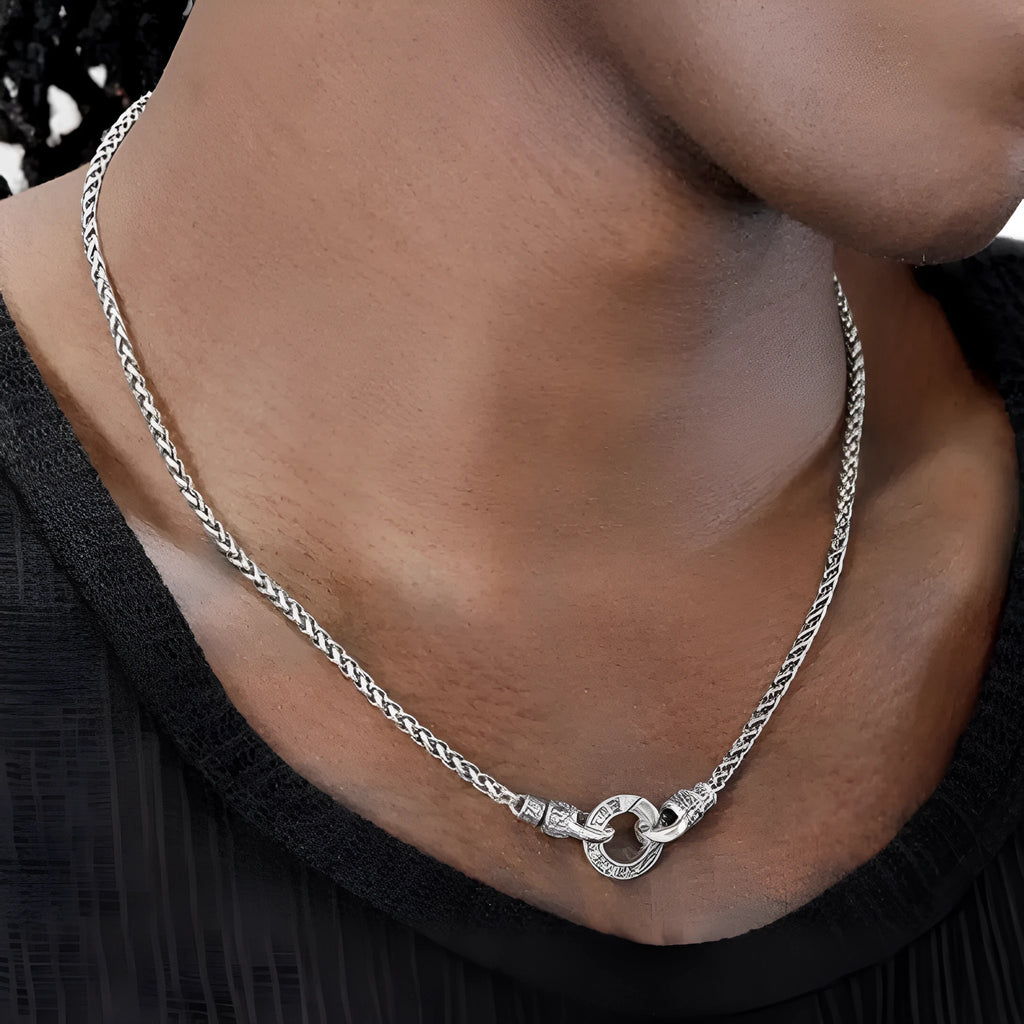 Close-up of a women's sterling silver clavicle necklace with a classic chain, shown against a neutral background.