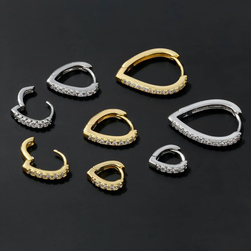 Simple geometric copper ear clip with heart design in gold or white finish.