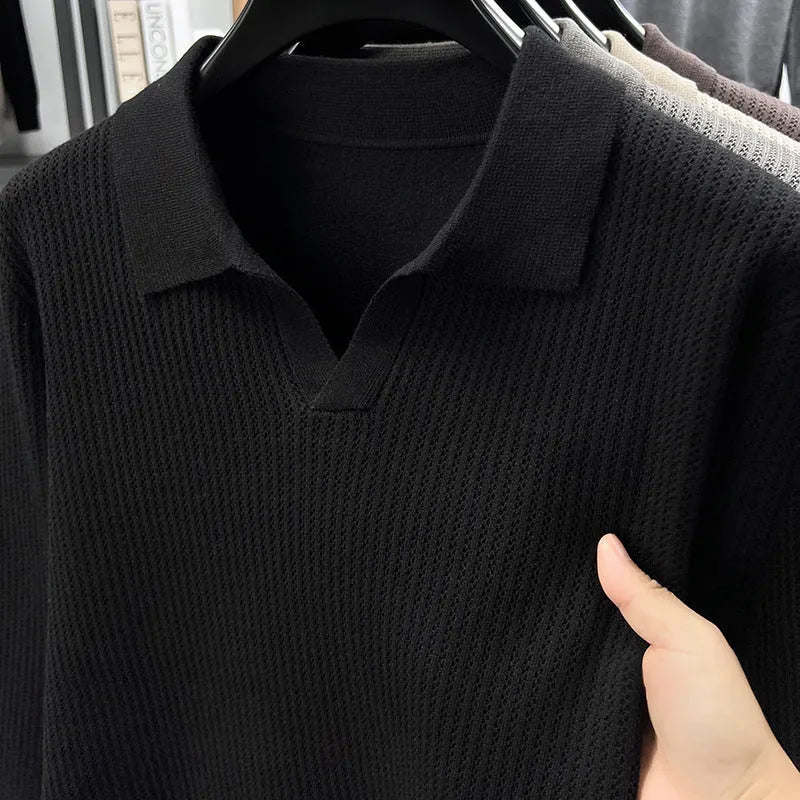 Men's loose green pullover sweater on a hanger, casual autumn wear.