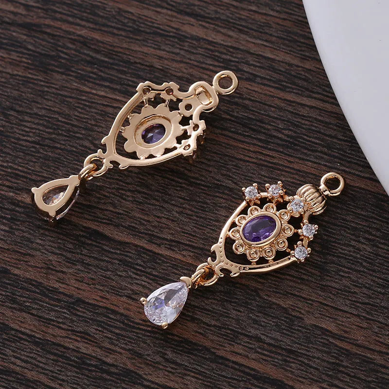 Water drop shaped pendant with crown design and micro inlaid zircon detail in electroplated copper.