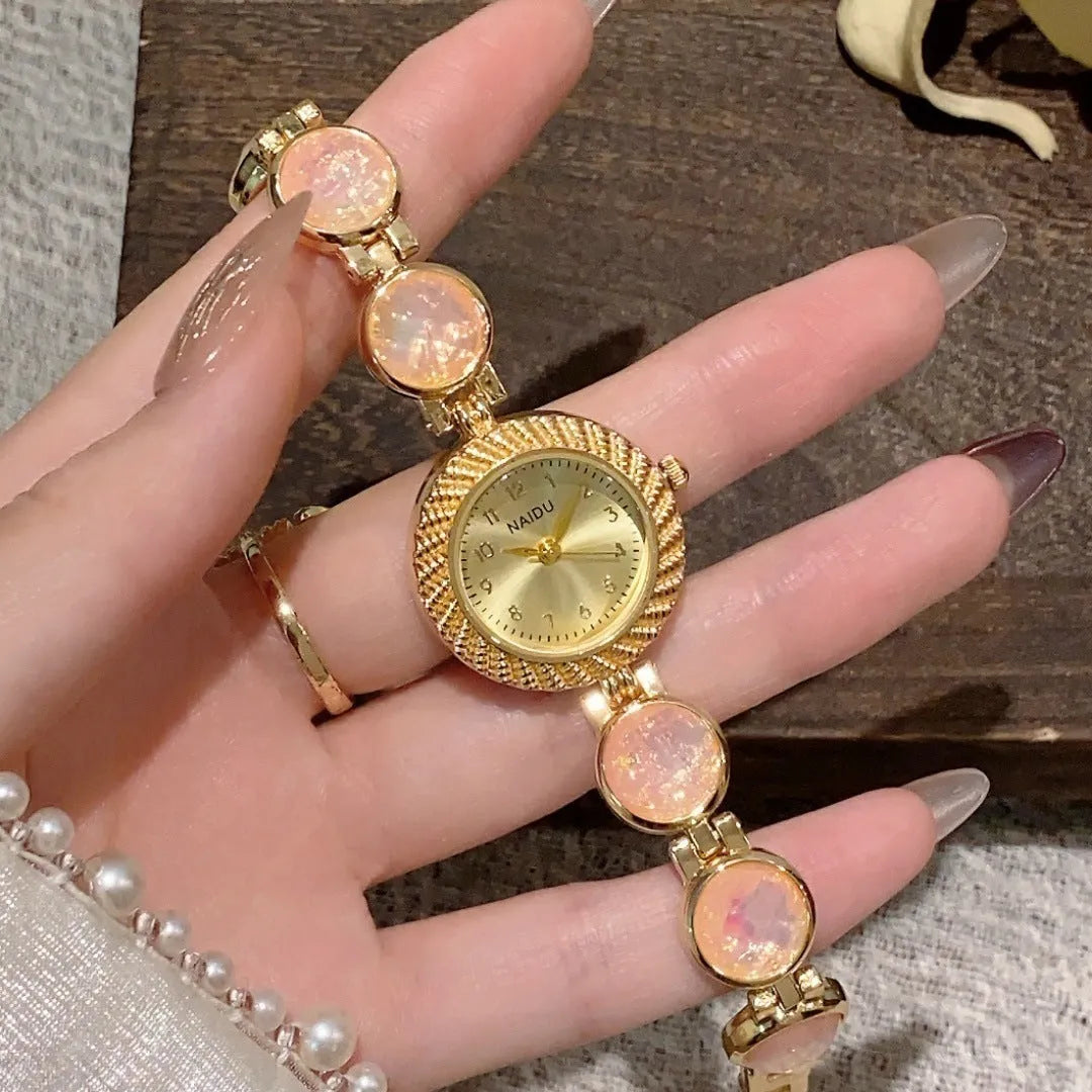 Women's quartz watch with 25mm round dial and zinc alloy case in milky white colour.