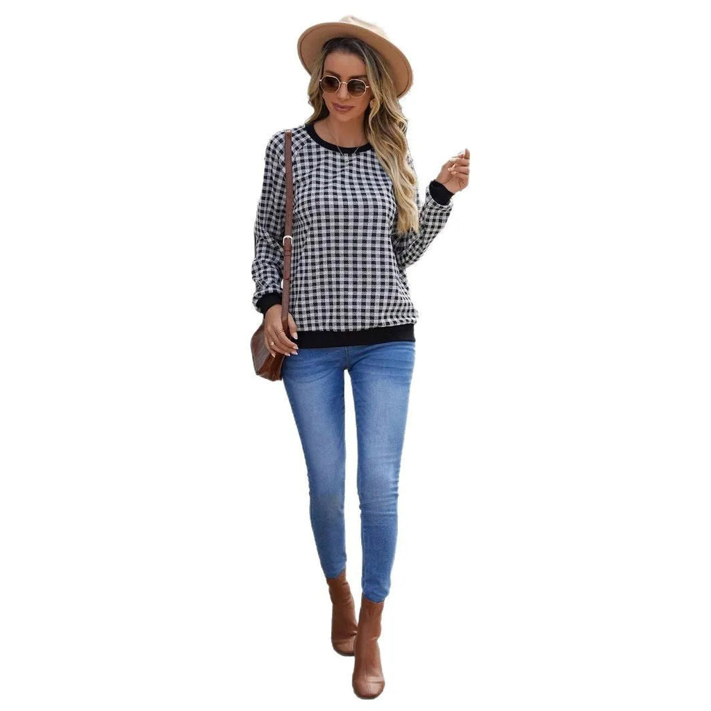 Black long sleeve pullover sweater with printed plaid and stripe pattern.