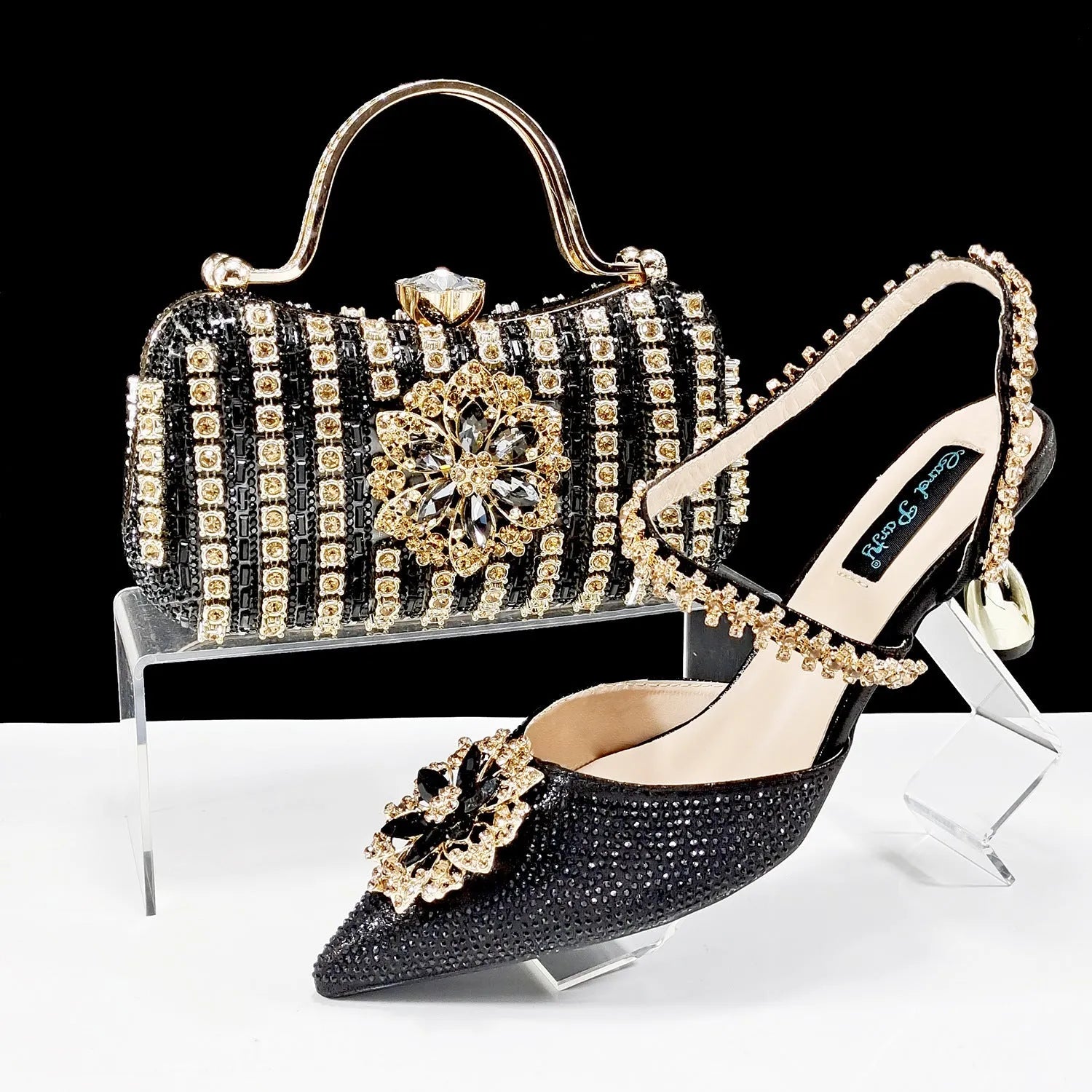 Women's black high heel shoes with matching clutch bag, decorative drill buckle flower ankle chain, and rhinestone details.